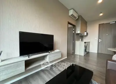 Modern living room with sleek TV unit and compact kitchen area