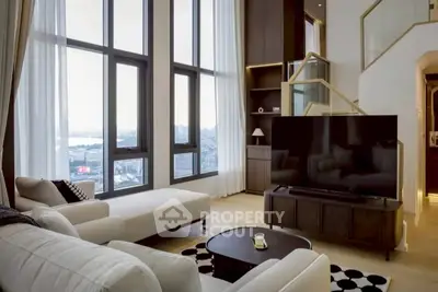 Luxurious high-rise living room with floor-to-ceiling windows and stunning city view.