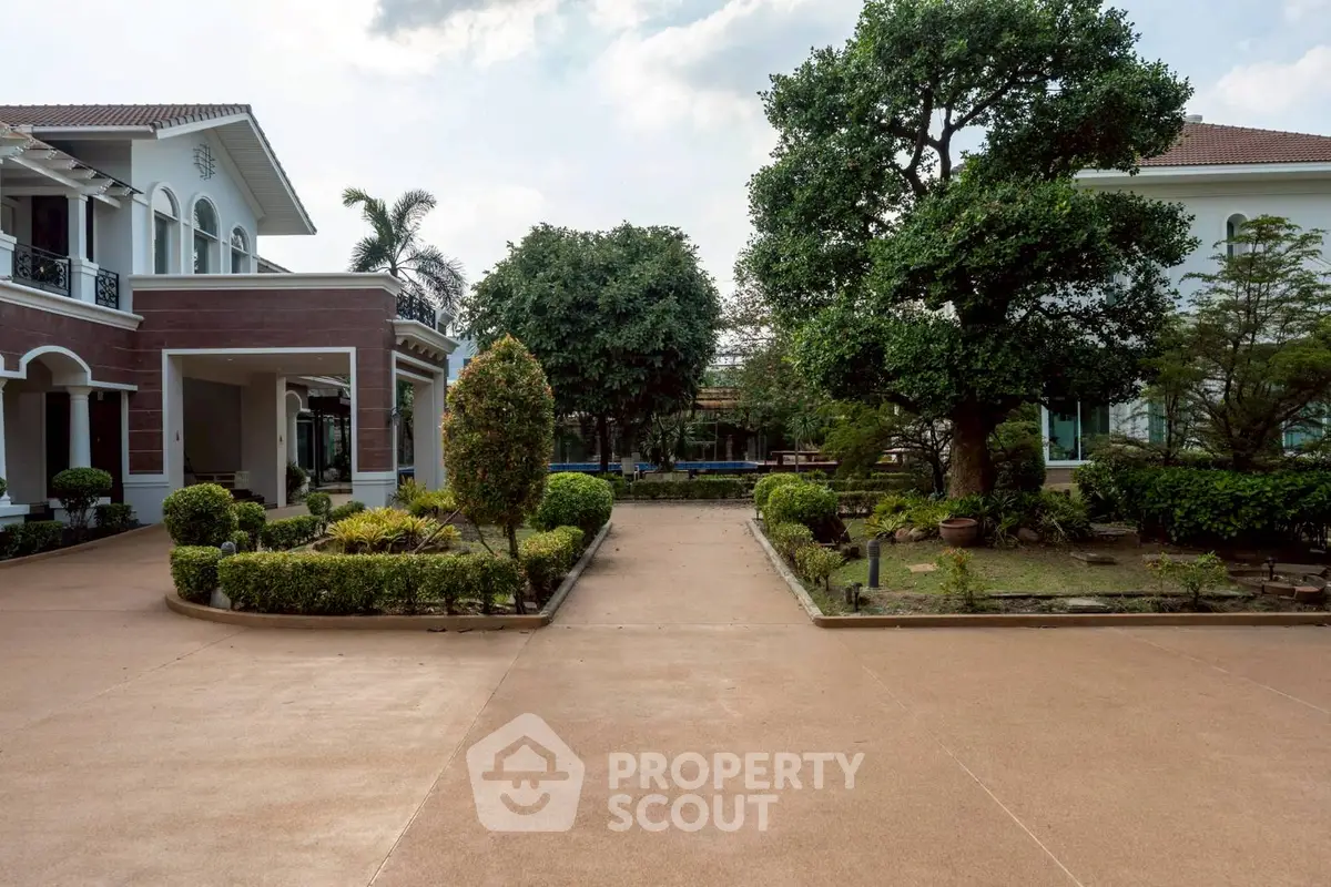 Elegant mansion with lush garden and spacious driveway