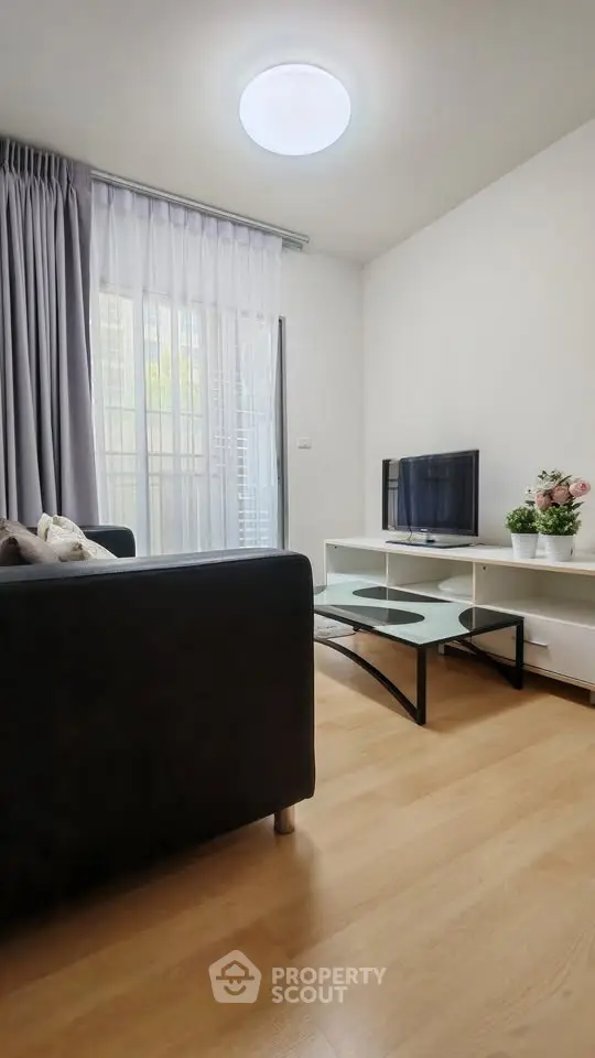 Cozy living room with modern furniture and natural light, perfect for relaxation.