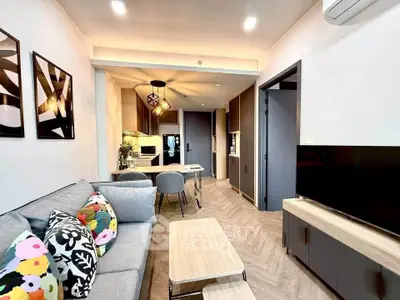 Modern living room with stylish decor and open kitchen layout in a cozy apartment.