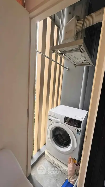 Compact balcony with washing machine and modern design elements.