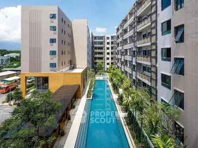 Luxurious residential complex with a stunning outdoor pool and lush greenery.