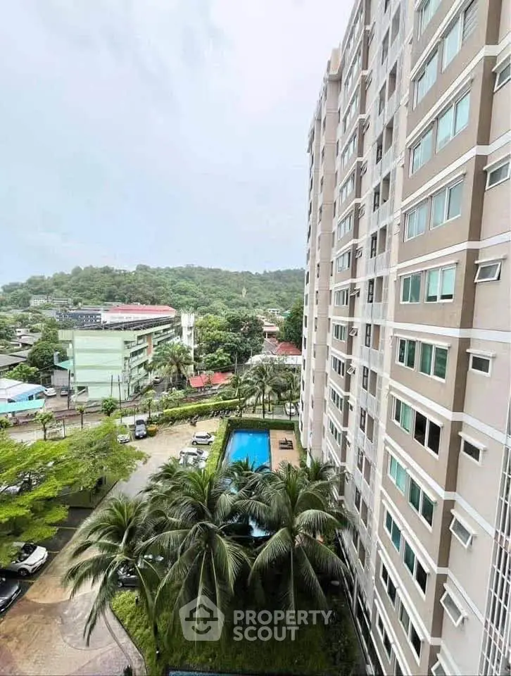 High-rise building with pool and lush greenery offering serene views.