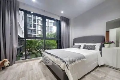 Modern bedroom with large window and stylish decor in urban apartment