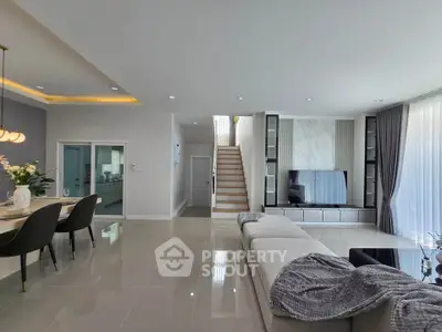 Spacious modern living room with elegant dining area and stylish decor