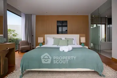 Luxurious modern bedroom with elegant decor and large windows offering natural light.