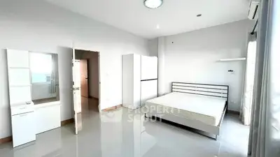 Spacious and bright bedroom with modern furnishings and ample natural light.