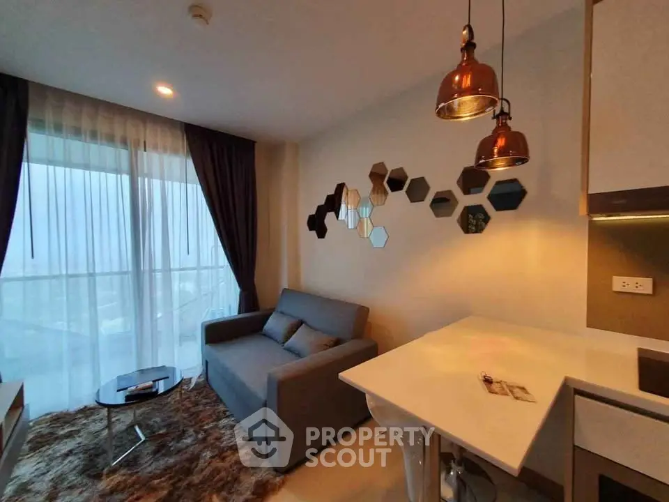 Modern living room with stylish decor and cozy seating in a high-rise apartment.