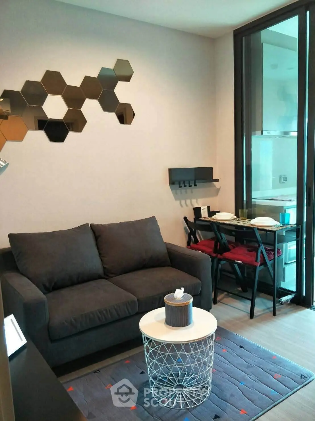 Modern living room with stylish decor and dining area in a cozy apartment.