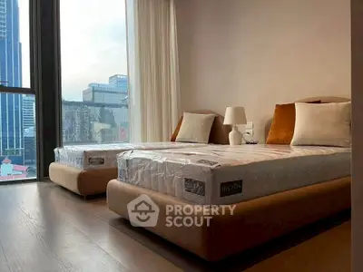 Modern bedroom with twin beds and city view, perfect for urban living.