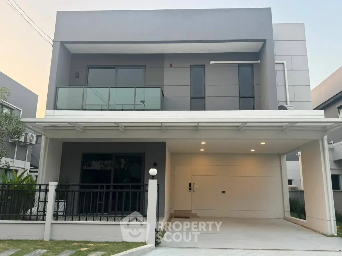 Modern two-story house with sleek design and spacious carport