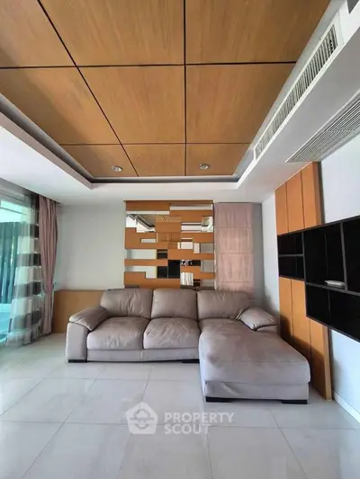 Spacious modern living room with stylish ceiling and comfortable sofa