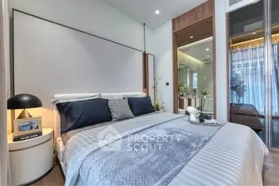 Luxurious modern bedroom with elegant decor and ambient lighting, featuring a cozy bed and stylish furnishings.