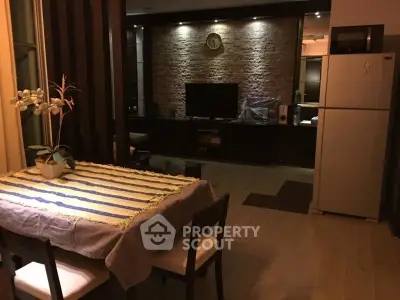 Cozy dining area with modern kitchen and stylish living room in open layout apartment.