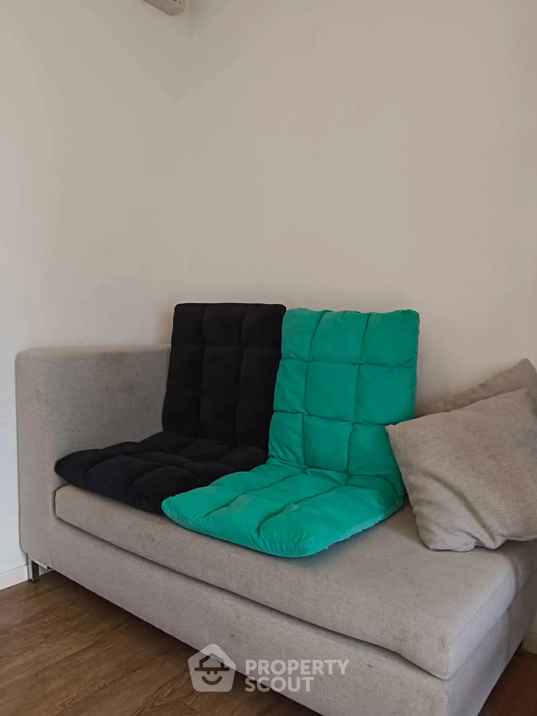 Cozy living room corner with modern sofa and colorful cushions