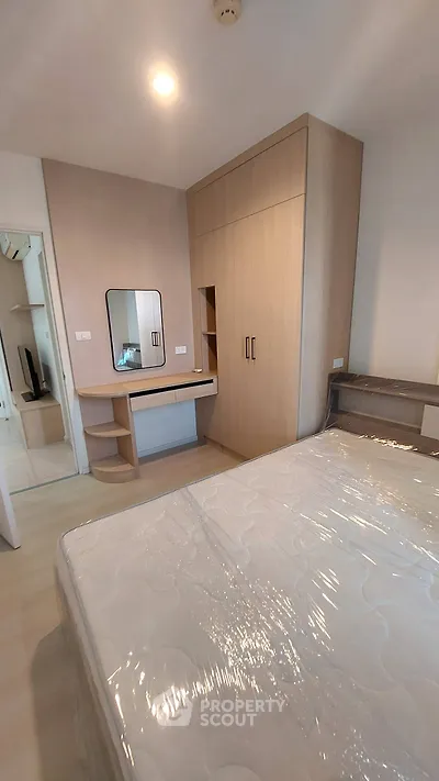 Modern bedroom with built-in wardrobe and stylish vanity in a cozy apartment.