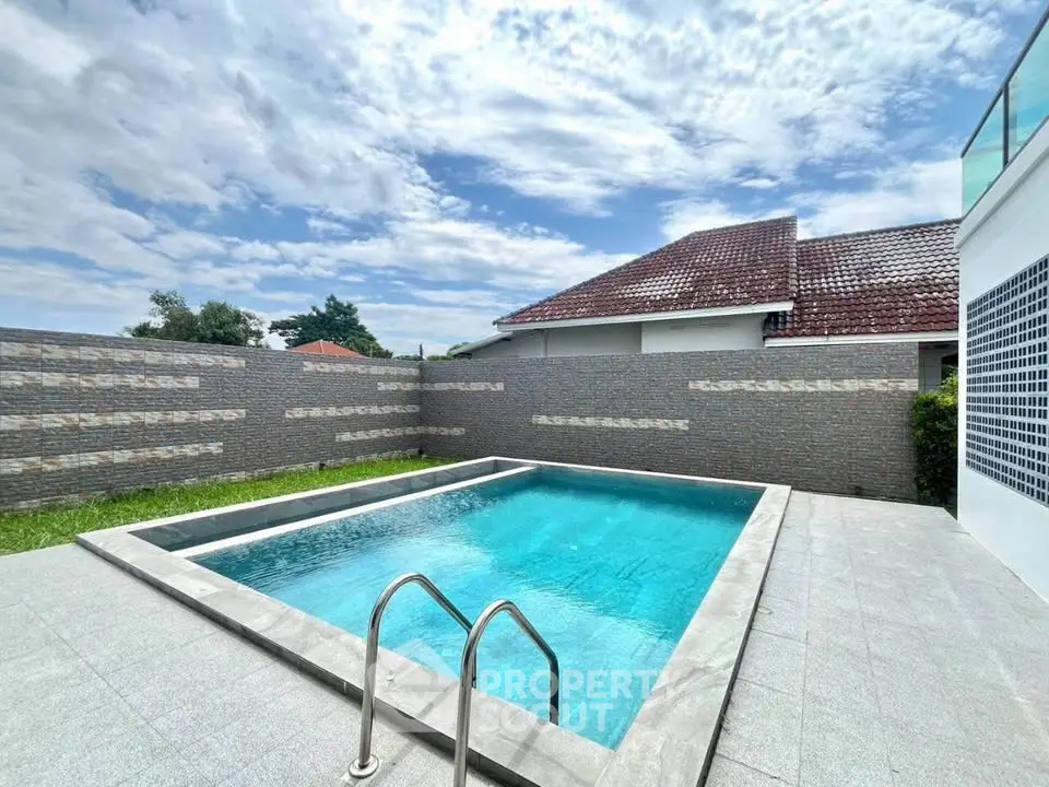 Stunning private pool in a modern backyard with clear blue skies.