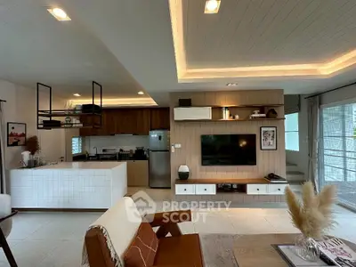 Modern open-plan living room with stylish kitchen and cozy decor
