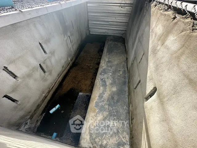 Concrete basement area with unfinished walls and flooring, potential for renovation or storage space.