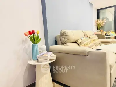 Modern living room with cozy sofa and stylish decor, perfect for relaxation and entertaining.