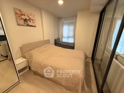 Cozy bedroom with modern decor and large mirrored wardrobe in a stylish apartment.
