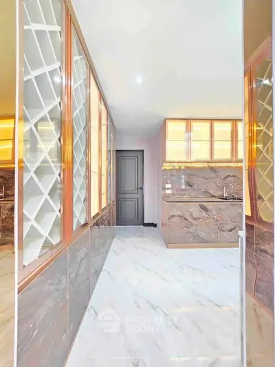 Luxurious kitchen with marble flooring and elegant cabinetry, perfect for modern living.