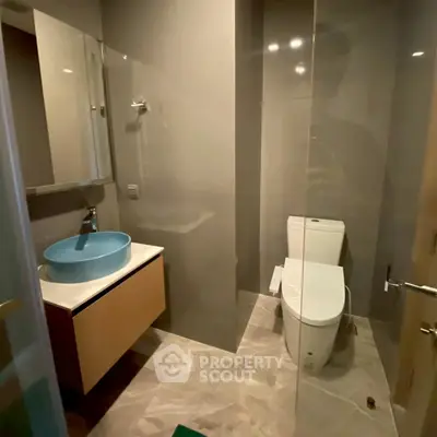 Modern bathroom with sleek design and stylish blue basin
