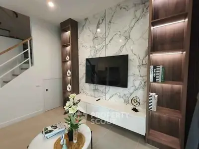 Modern living room with marble accent wall and built-in shelves