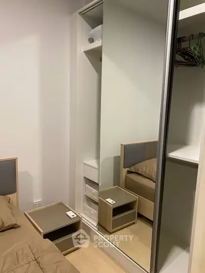 Modern bedroom with mirrored wardrobe and cozy bed setup