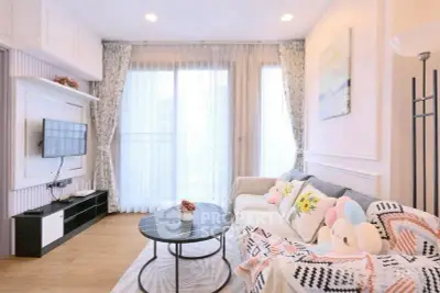 Charming living room with cozy decor and natural light, perfect for relaxation.