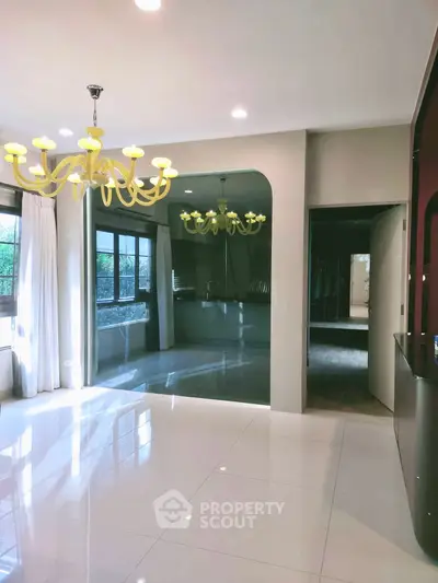 Elegant living room with modern chandelier and large windows for natural light