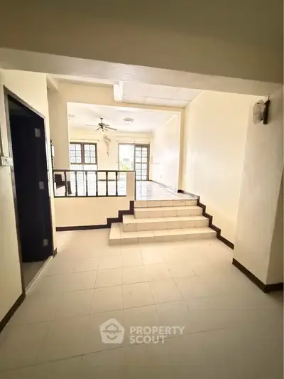 Spacious interior with elevated living area and large windows for natural light.