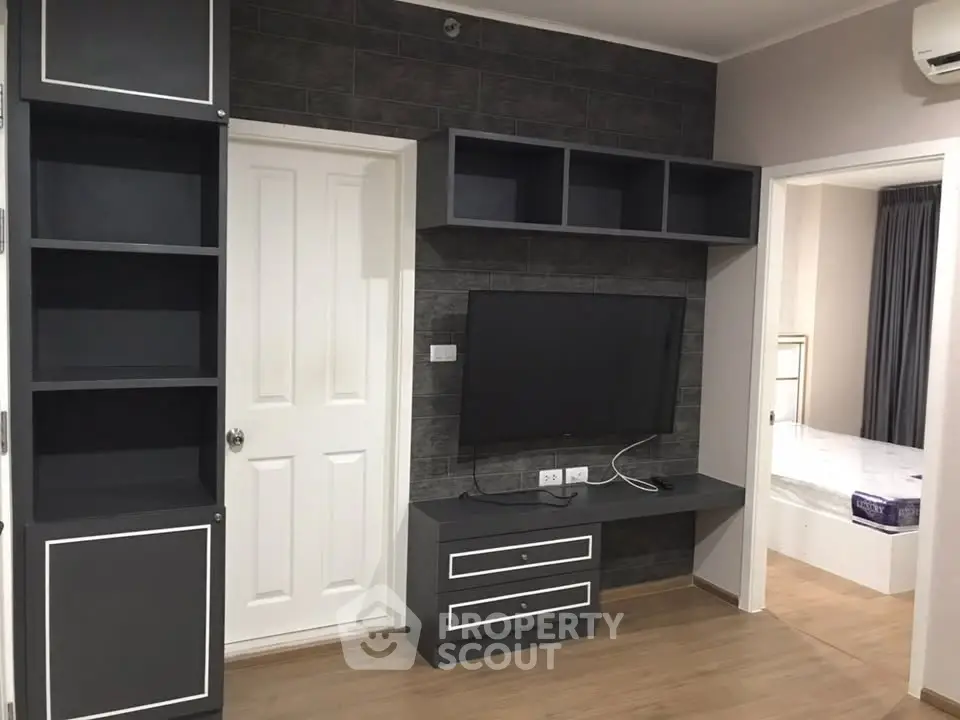 Modern living room with built-in TV unit and sleek storage solutions.