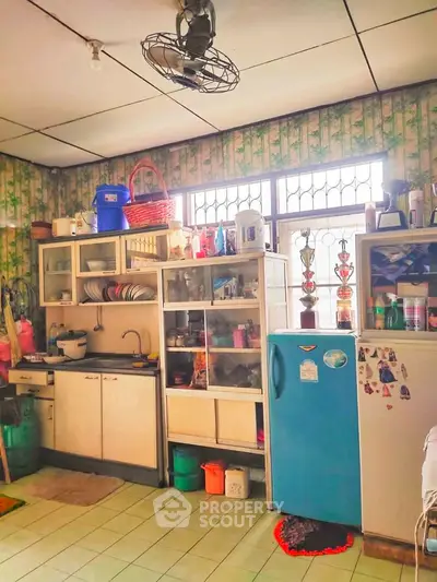 Charming vintage kitchen with retro fridge and ample storage space, perfect for cozy home cooking.