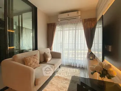 Cozy living room with modern decor, plush sofa, and large window offering natural light.