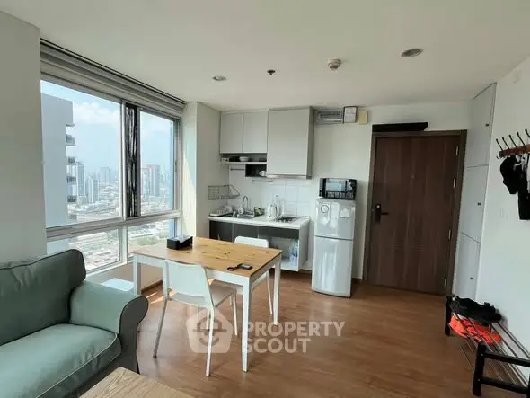 Modern apartment with open kitchen and city view, featuring cozy living area and dining space.