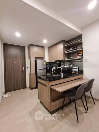 Modern kitchen with sleek cabinetry and breakfast bar in a stylish apartment