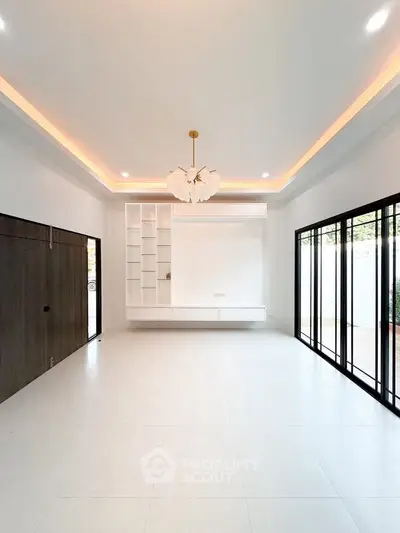Spacious modern living room with elegant lighting and large windows for natural light.