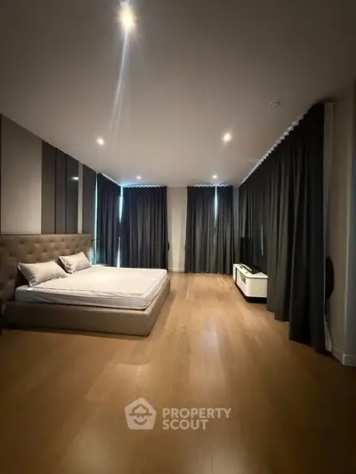 Spacious modern bedroom with elegant design and wooden flooring