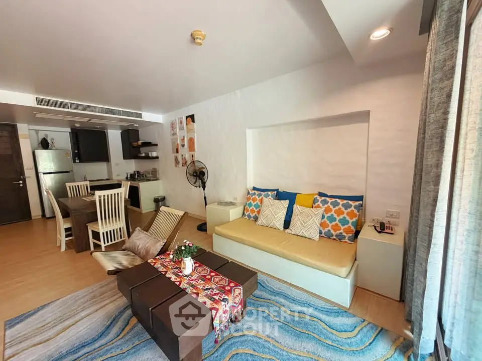 Spacious living room with modern decor and open kitchen layout