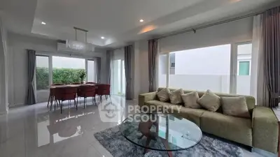 Spacious modern living room with elegant dining area and large windows