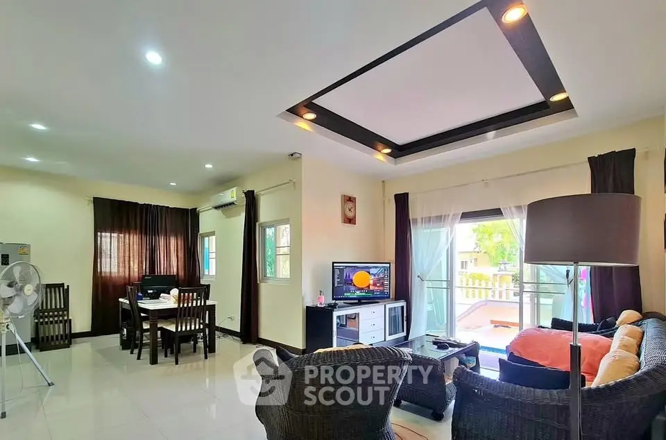 Spacious living room with modern decor and large windows for natural light.