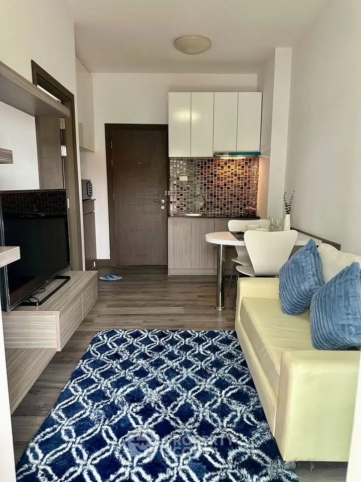 Modern compact living room with stylish kitchen and cozy seating area