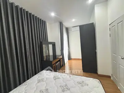 Spacious bedroom with modern furnishings and ample natural light