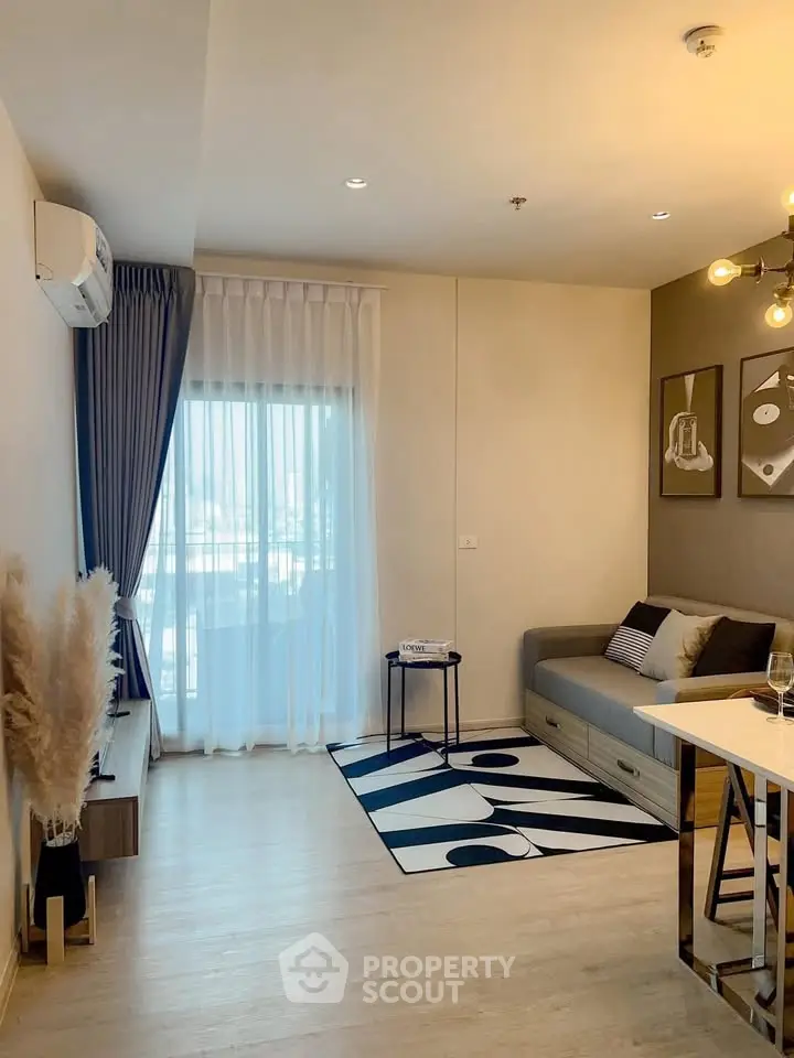 Modern living room with stylish decor, large window, and cozy seating area in a contemporary apartment.