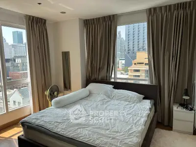 Spacious bedroom with city view and natural light in modern apartment