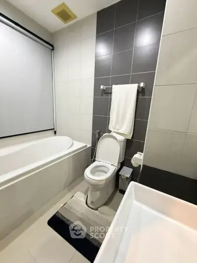 Modern bathroom with bathtub and sleek tile design