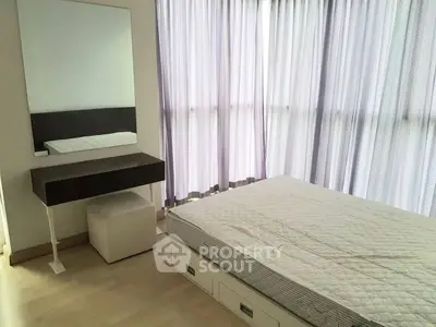 Bright bedroom with large window and modern furniture