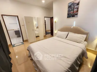 Elegant bedroom with modern decor and cozy lighting, featuring a comfortable bed and spacious wardrobe.